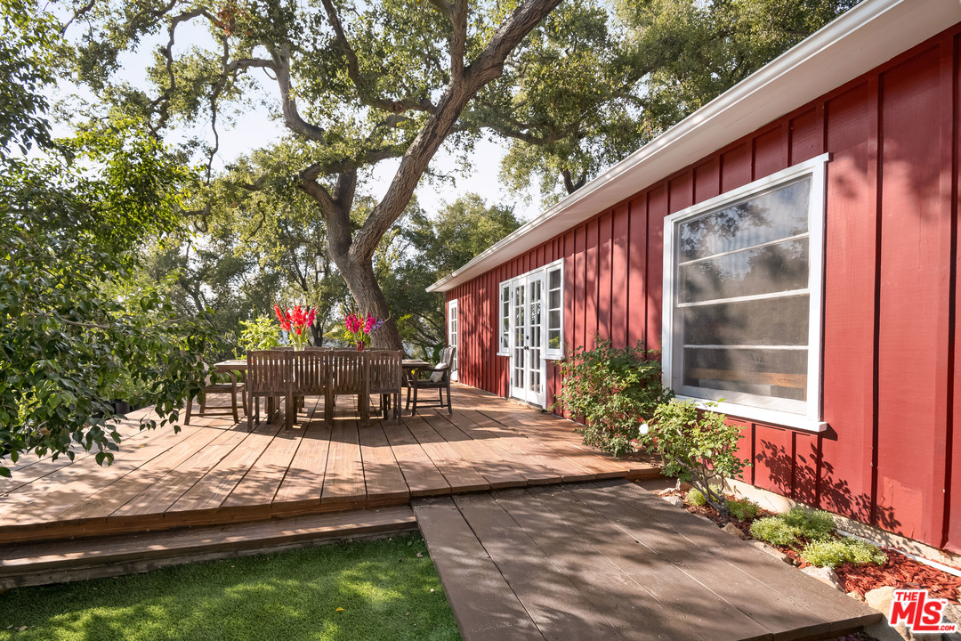 21042 Entrada Road Topanga, CA 90290 - Photo 6 of 49 a wooden bench sitting in front of a house