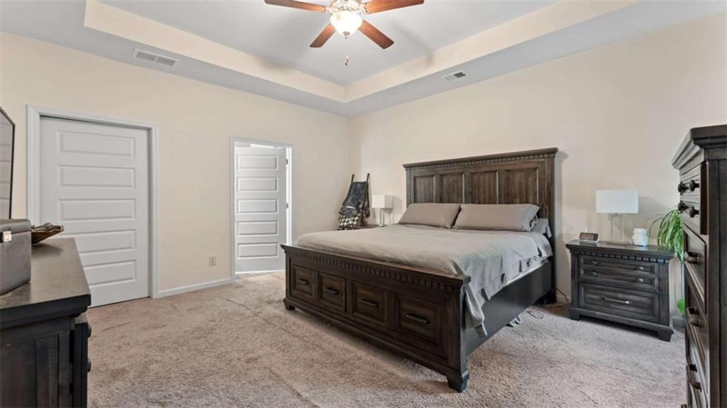 13 Oak View Drive Northeast Rome, GA 30165 - Photo 12 of 26 a bedroom with a bed a dresser and a chandelier