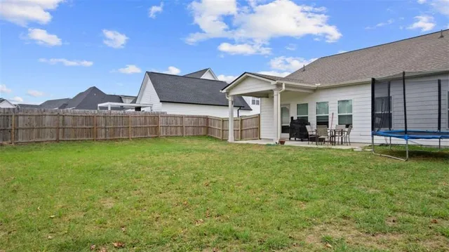 an aerial view of a house with a garden and swimming pool