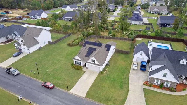 an aerial view of residential houses with outdoor space
