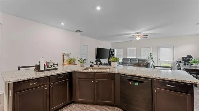 a bedroom with a bed and a flat tv screen on dresser