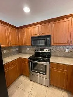 a bathroom with a granite countertop sink and washing machine