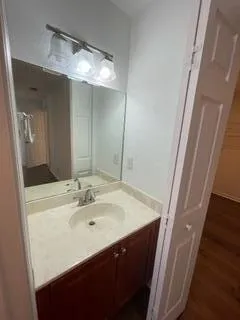 a view of a room with wooden floor and a window
