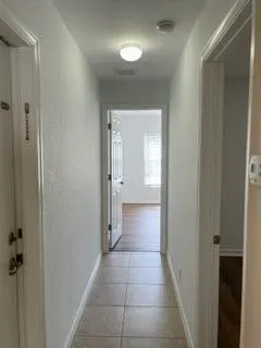 a view of a room with wooden floor and a window