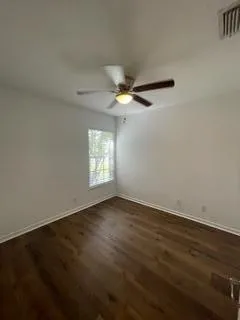an empty room with wooden floor and closet