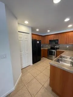 a stove top oven sitting inside of a kitchen