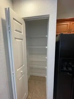 a kitchen with granite countertop a stove top oven microwave and cabinets