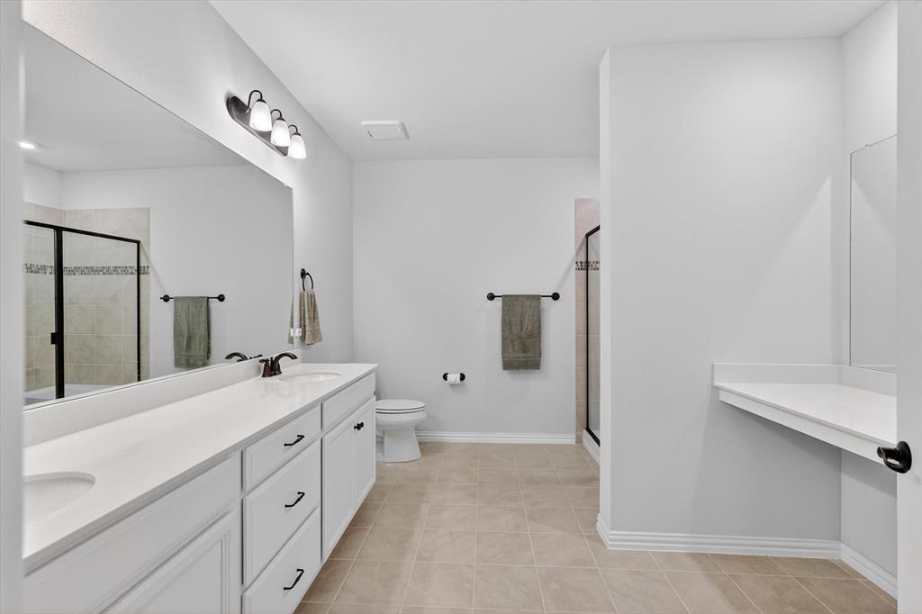 651 Watters Road, Unit 5305 Allen, TX 75013 - Photo 17 of 40 a spacious bathroom with double vanity a mirror and a shower