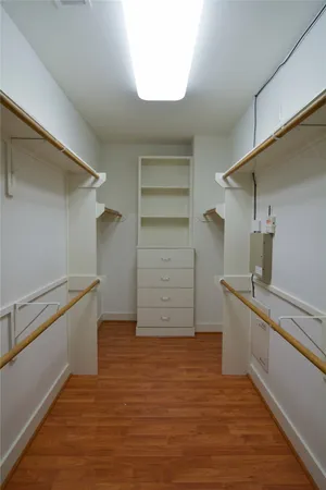 a view of a kitchen with wooden floor and electronic appliances