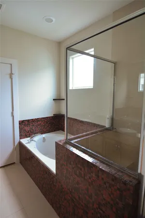 a bath tub sitting in a bathroom next to a sink