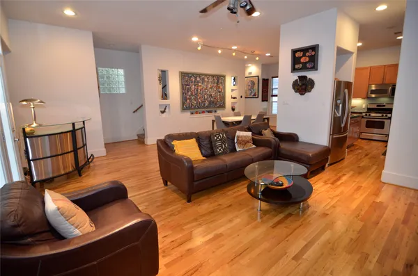 a living room with furniture and wooden floor