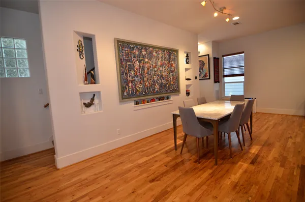 a view of a dining room with furniture and wooden floor