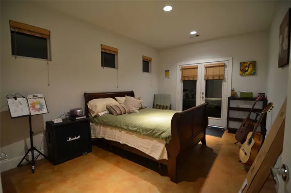 a bedroom with a bed window and chair