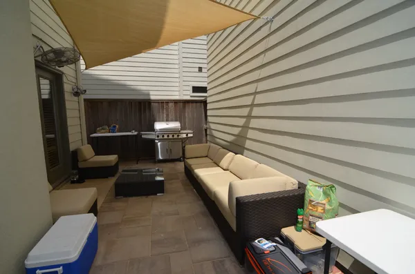 a patio with patio couch and chairs