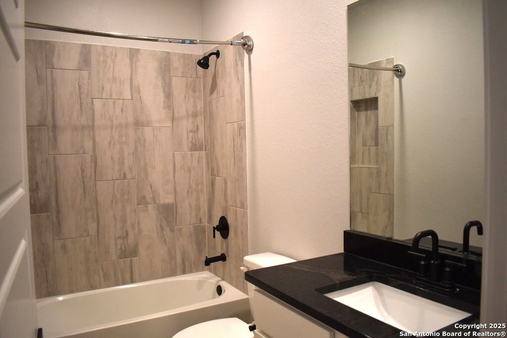 9210 Espadrille Run Converse, TX 78109 - Photo 11 of 17 a bathroom with a granite countertop sink and a mirror