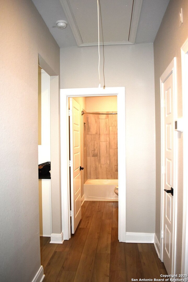 9210 Espadrille Run Converse, TX 78109 - Photo 12 of 17 a view of a hallway with wooden floor and cabinet