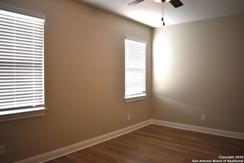 9210 Espadrille Run Converse, TX 78109 - Photo 6 of 17 an empty room with wooden floor and windows