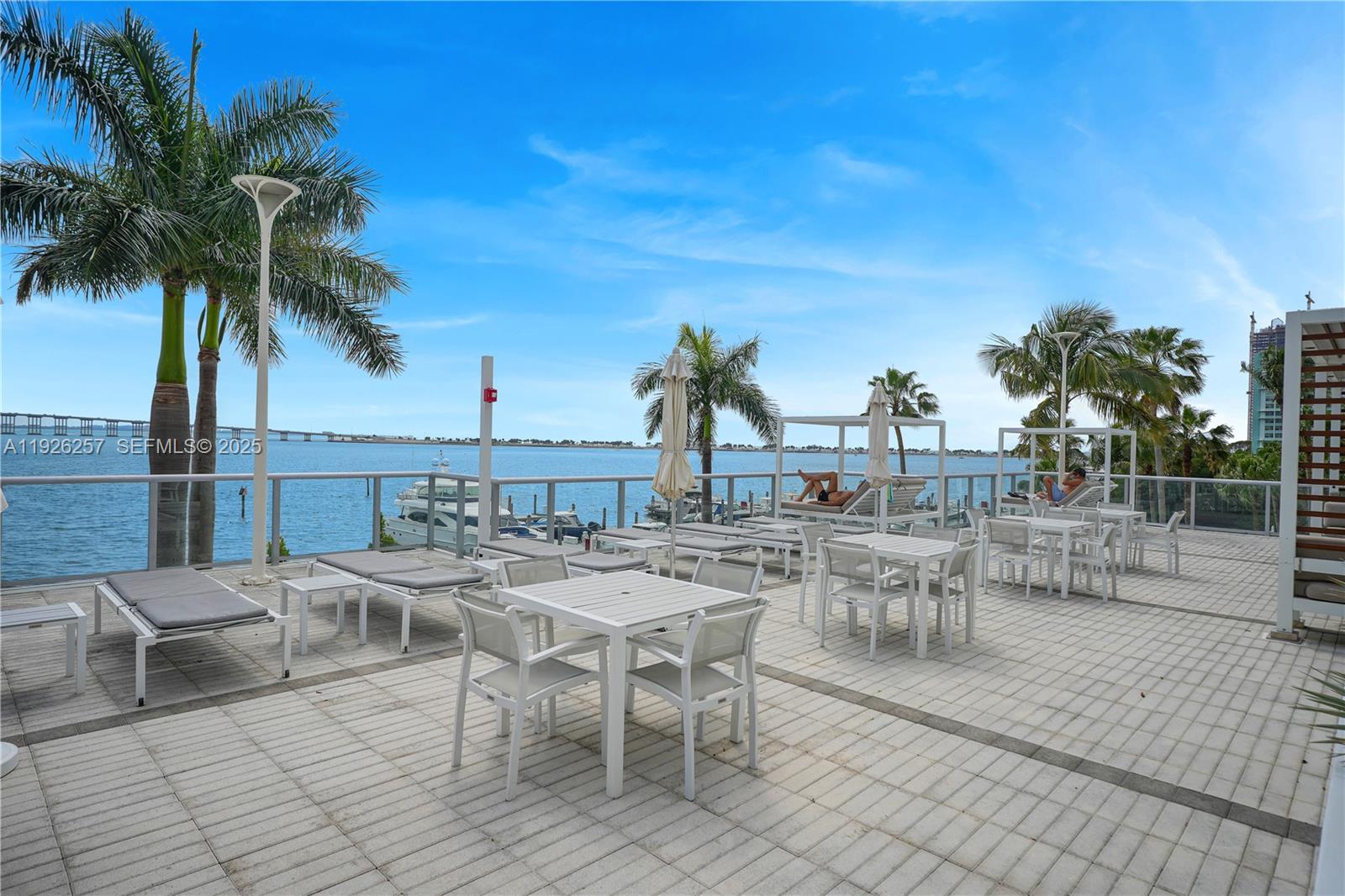 1541 Brickell Avenue, Unit A1201 Miami, FL 33129 - Photo 17 of 17 a view of a patio with chairs and tables