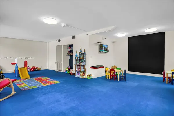 a view of ocean with boats and palm trees