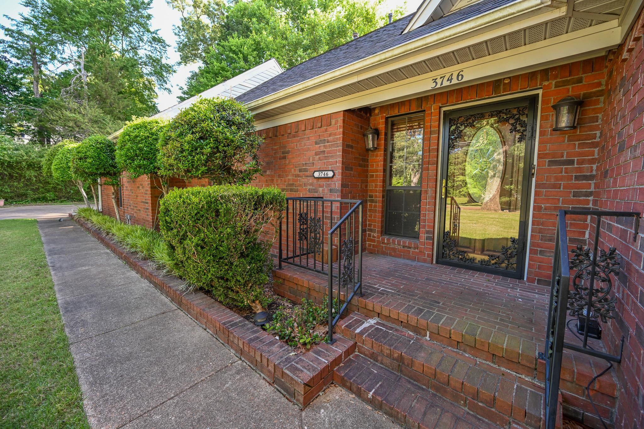 3746 Broadway Road Bartlett, TN 38135 - Photo 3 of 39 Brick exterior with a brick-paved front entry, featuring a decorative glass storm door, side light window, and black wrought iron railings.