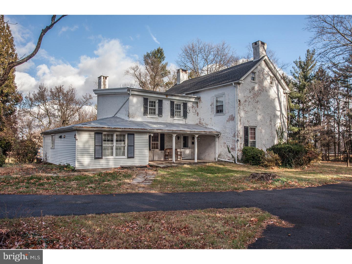 2963 Windy Bush Road Newtown, PA 18940 - Photo 3 of 16 a view of a white house next to a yard with big trees