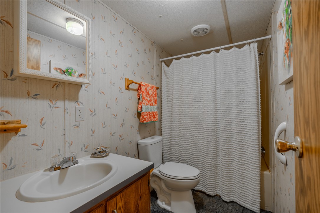 121 Kountry Lane Walhalla, SC 29691 - Photo 24 of 31 This bathroom features a classic vanity with a sink, toilet, and a practical shower.