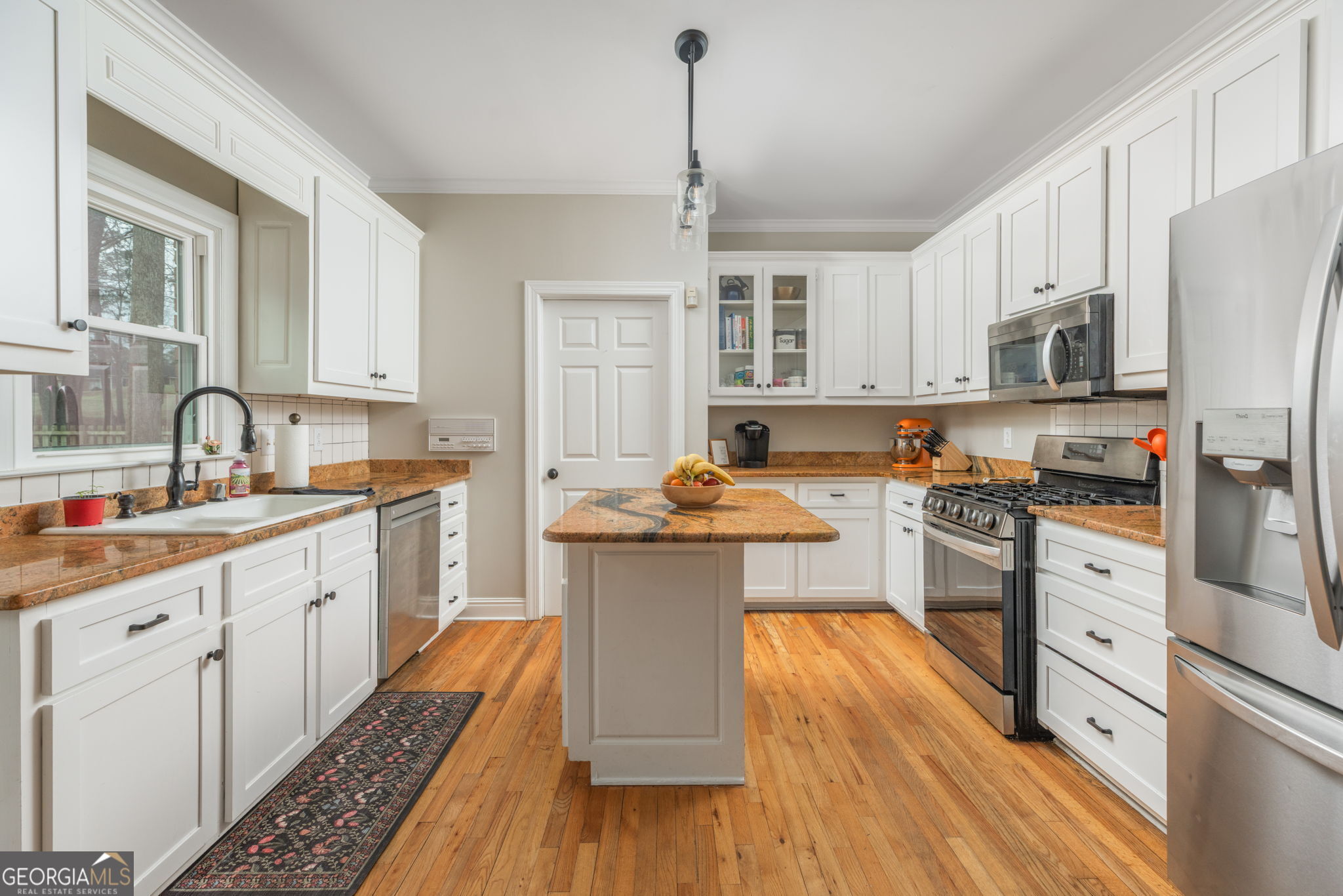 144 Cambridge Way Macon, GA 31220 - Photo 16 of 50 a kitchen with a refrigerator a stove top oven a sink dishwasher and white cabinets with wooden floor