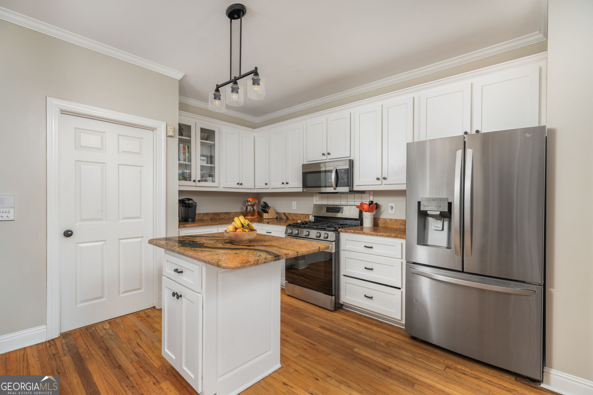 144 Cambridge Way Macon, GA 31220 - Photo 17 of 50 a kitchen with stainless steel appliances granite countertop a refrigerator a stove a sink dishwasher a microwave oven with white cabinets and wooden floor