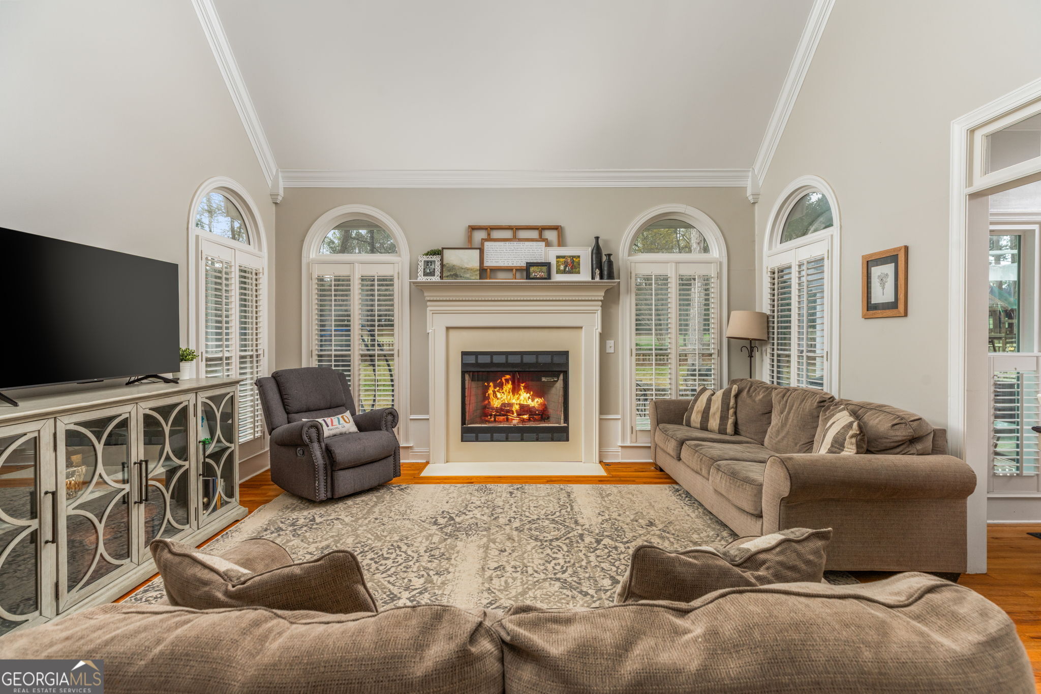 144 Cambridge Way Macon, GA 31220 - Photo 10 of 50 a living room with furniture a flat screen tv and a fireplace