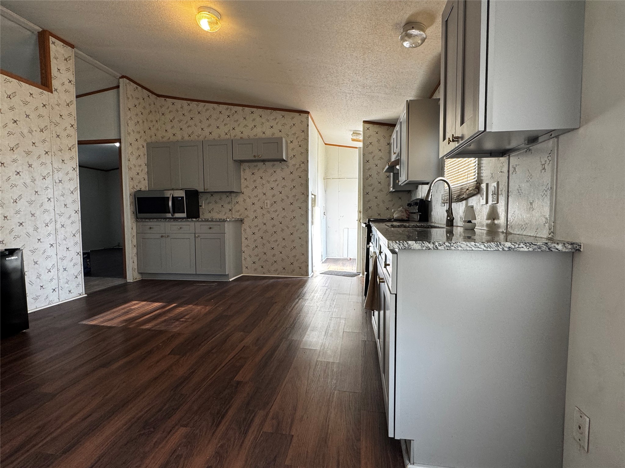 15930 Boss Gaston Road Sugar Land, TX 77498 - Photo 8 of 20 a kitchen with stainless steel appliances granite countertop a refrigerator a stove and a wooden floors