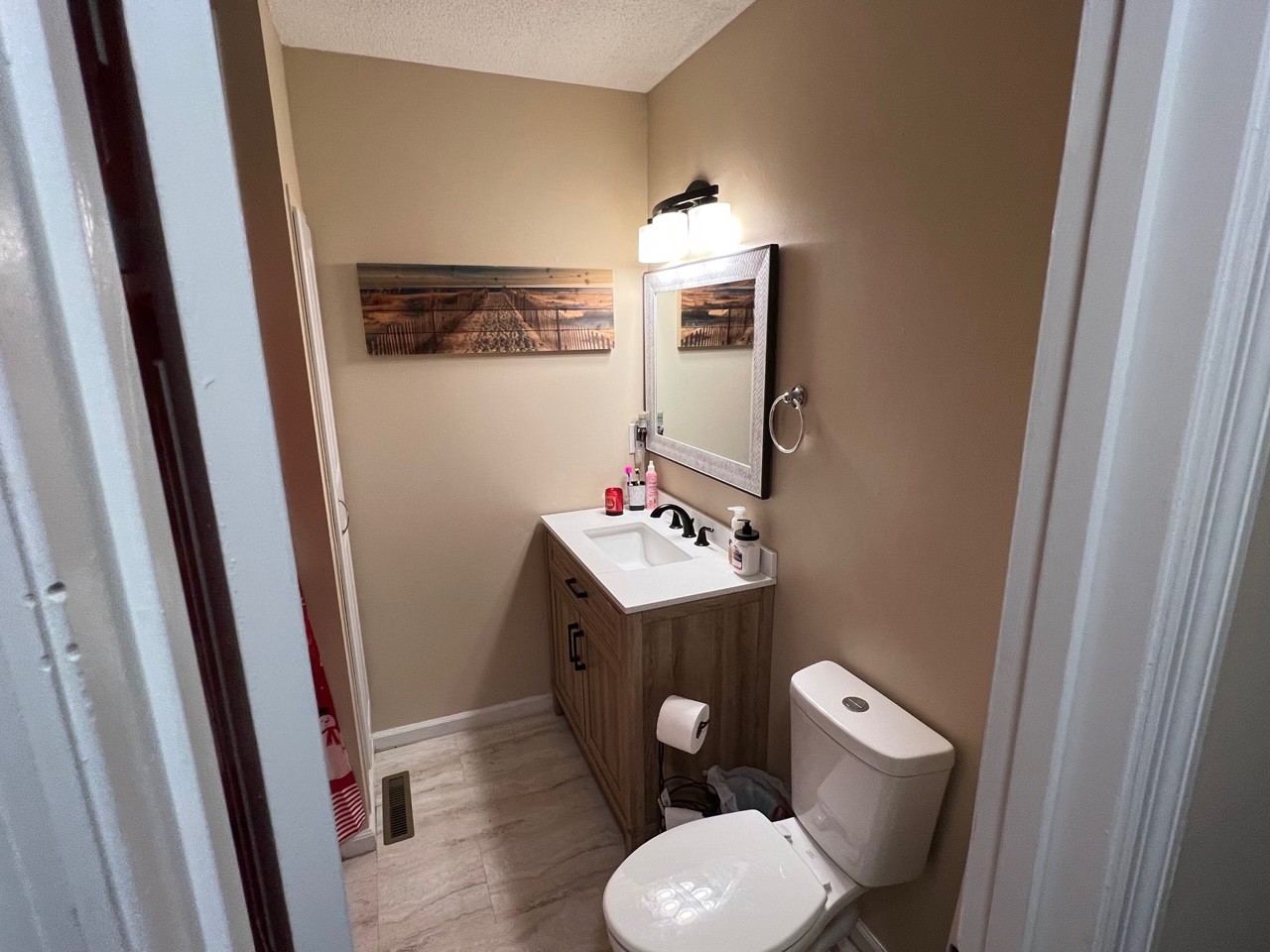 1018 Riley Creek Road Tullahoma, TN 37388 - Photo 17 of 26 a bathroom with a toilet sink and mirror