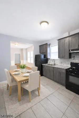 a large kitchen with a table and chairs