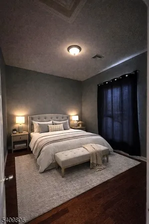 a bedroom with a bed and a night stand