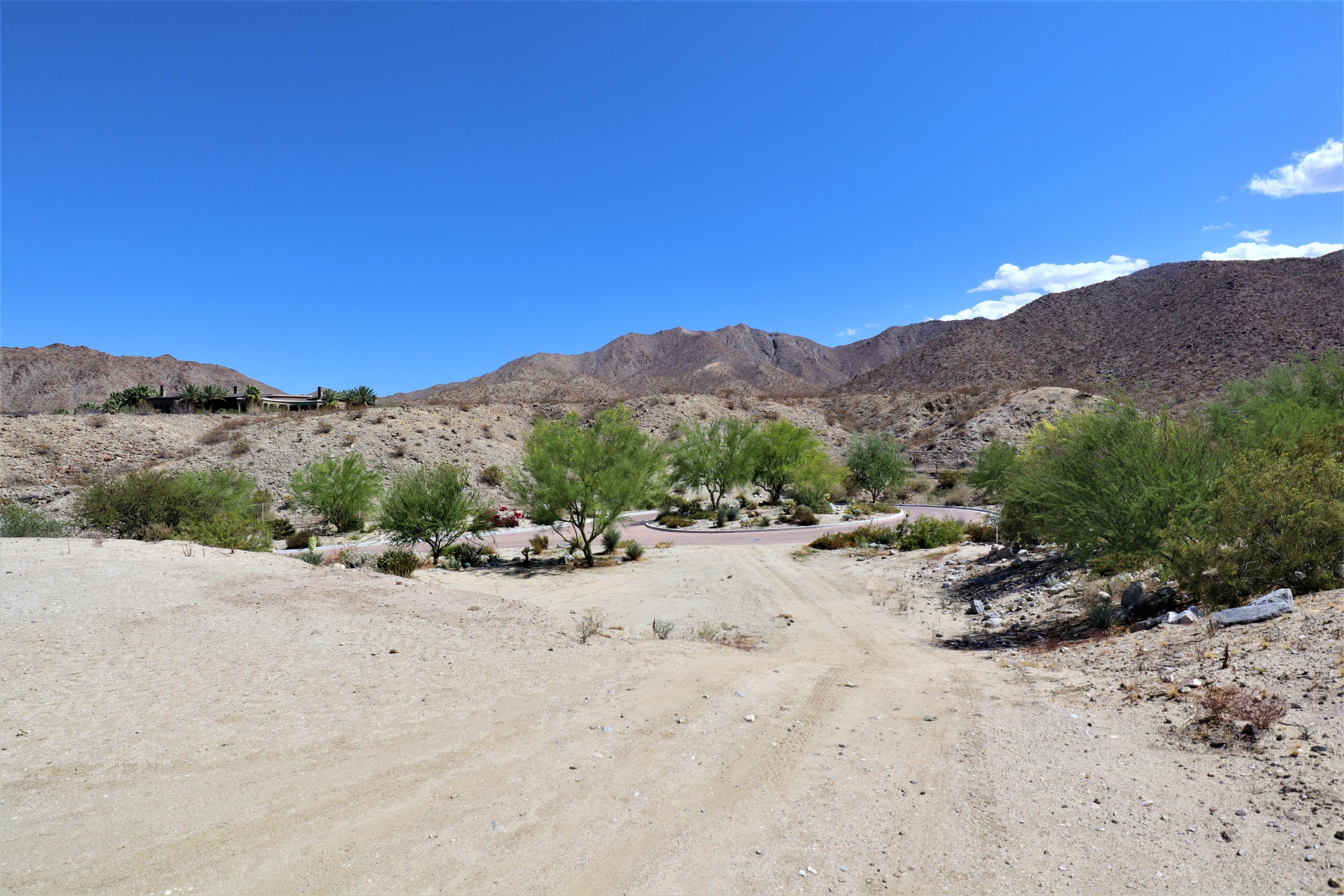 626 Cornishe Cove Palm Desert, CA 92260 - Photo 1 of 7 a view of a dry field with mountains in the background