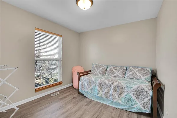 a view of workspace room with furniture and wooden floor