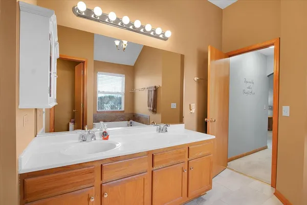a bathroom with a double vanity sink and a mirror