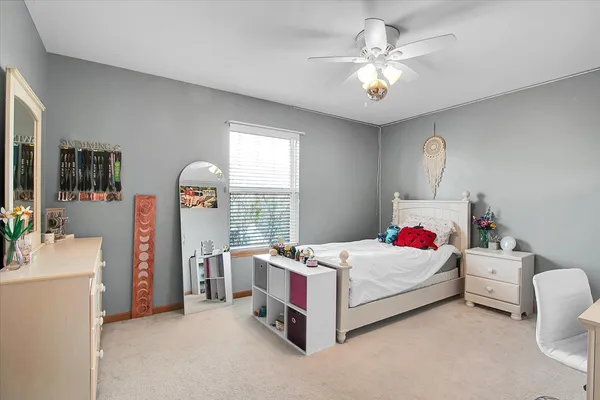 a bedroom with a bed closet and a large window