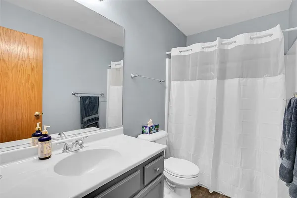 a bathroom with a sink toilet and shower