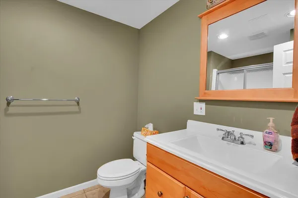 a bathroom with a sink a toilet and a mirror