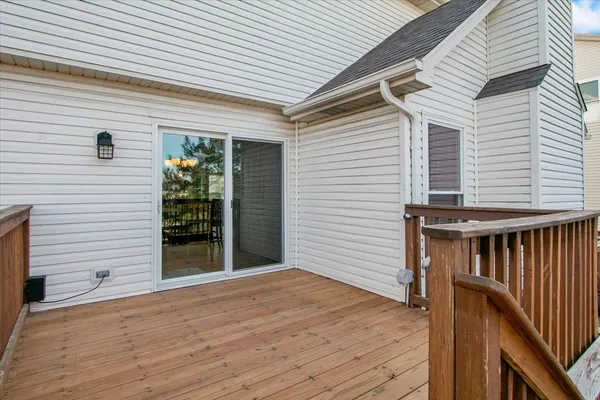 a view of backyard with a deck and wooden floor