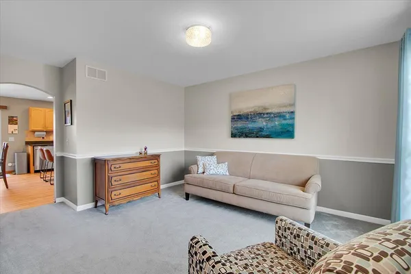 a living room with furniture and a lamp