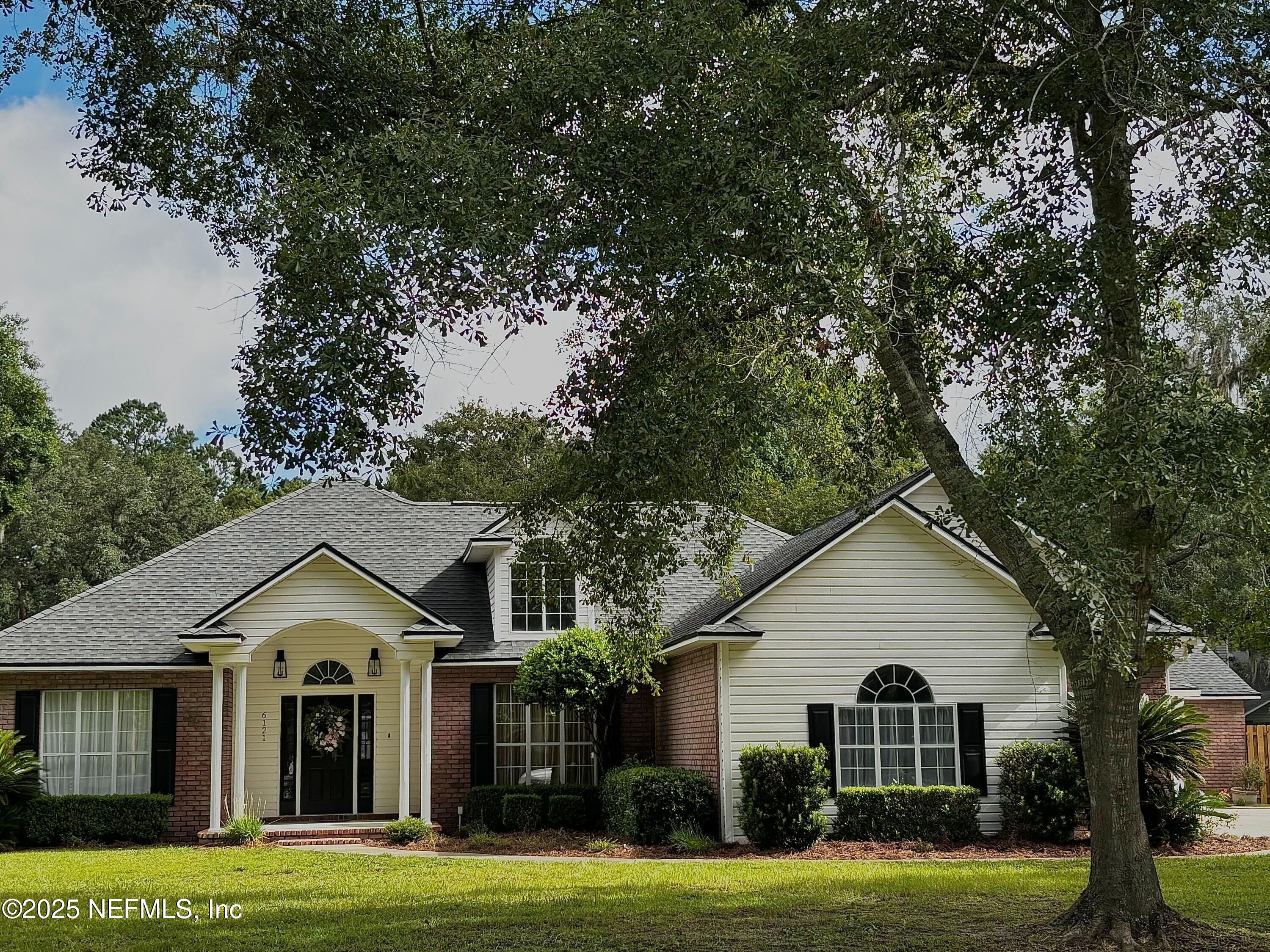 a view of a big yard in front of a house
