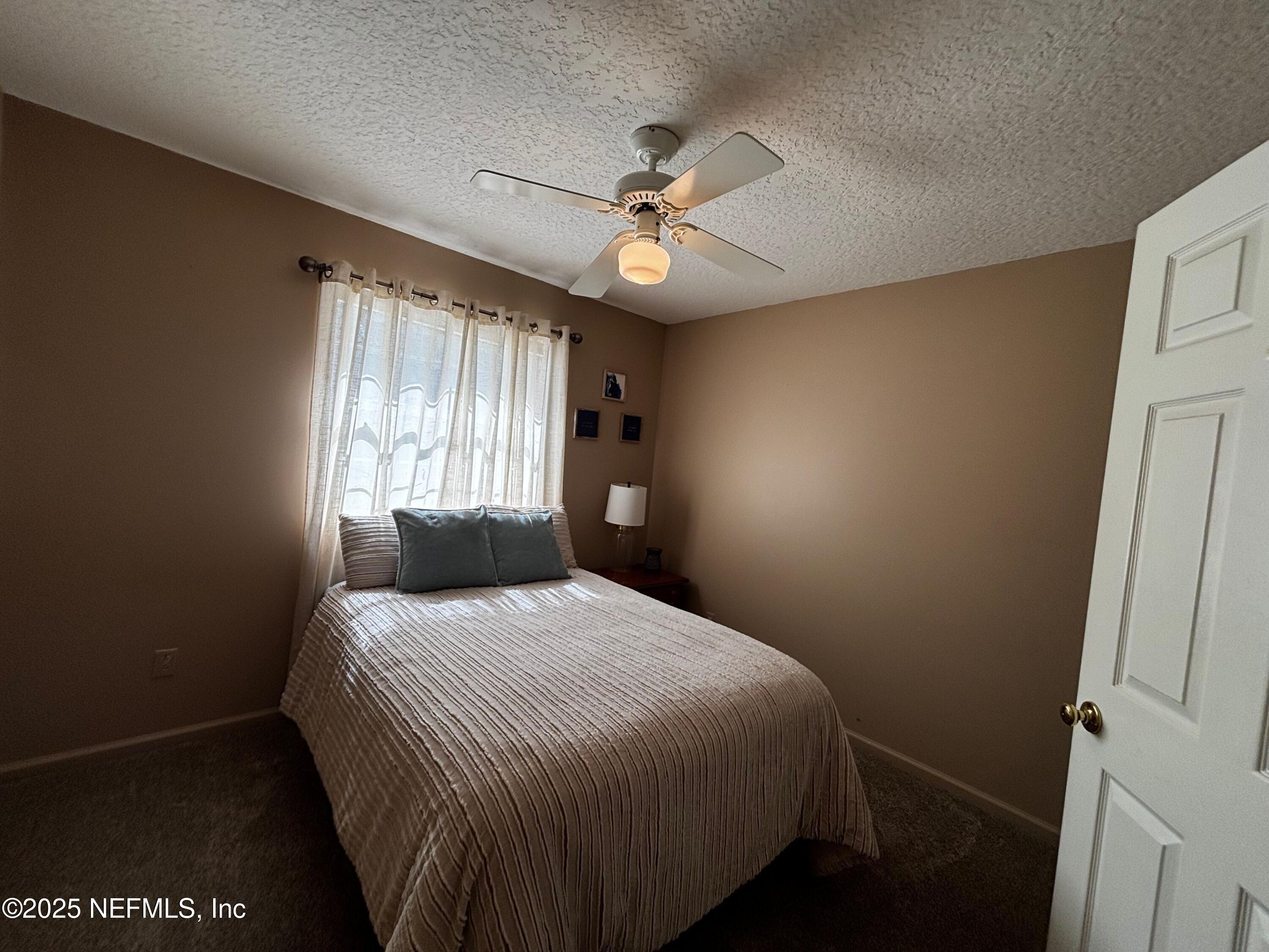 6121 Michele Road Macclenny, FL 32063 - Photo 19 of 26 a bedroom with a bed and a window
