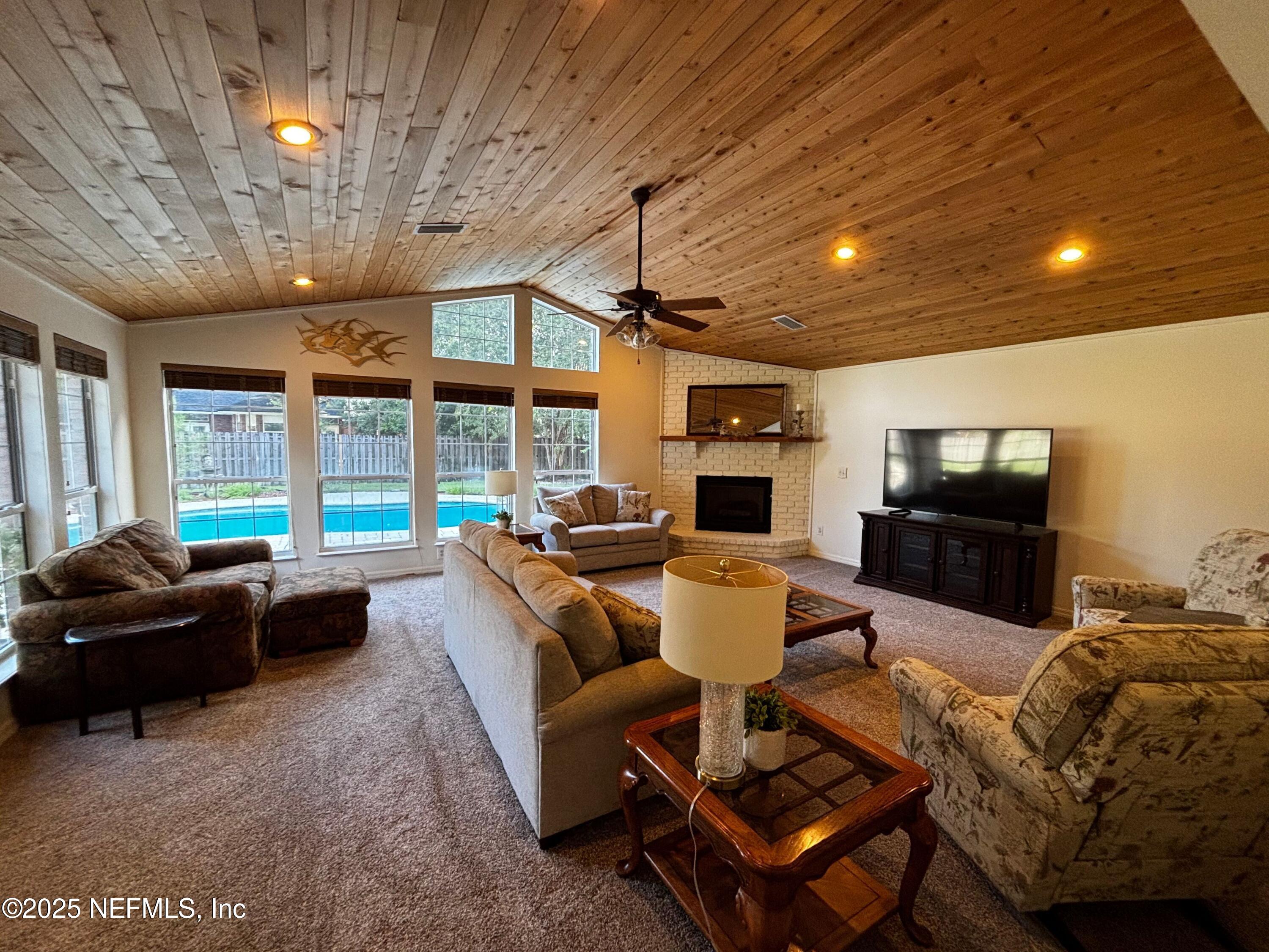 6121 Michele Road Macclenny, FL 32063 - Photo 3 of 26 a living room with furniture a flat screen tv and a large window