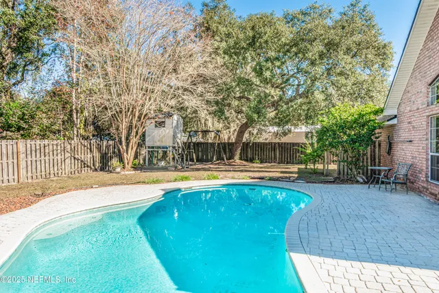 a swimming pool with outdoor seating and yard