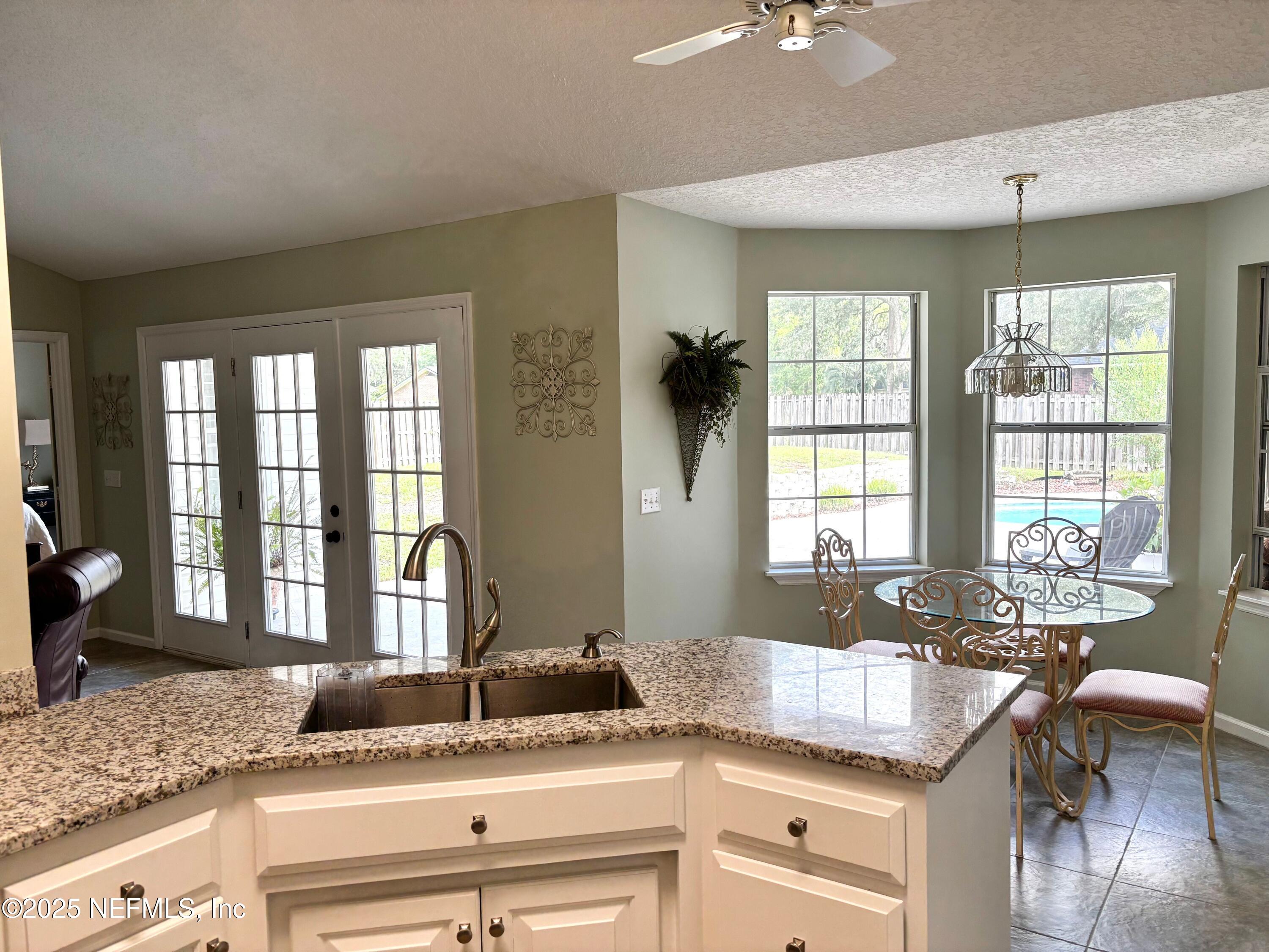 6121 Michele Road Macclenny, FL 32063 - Photo 6 of 26 a kitchen with granite countertop a sink and a window