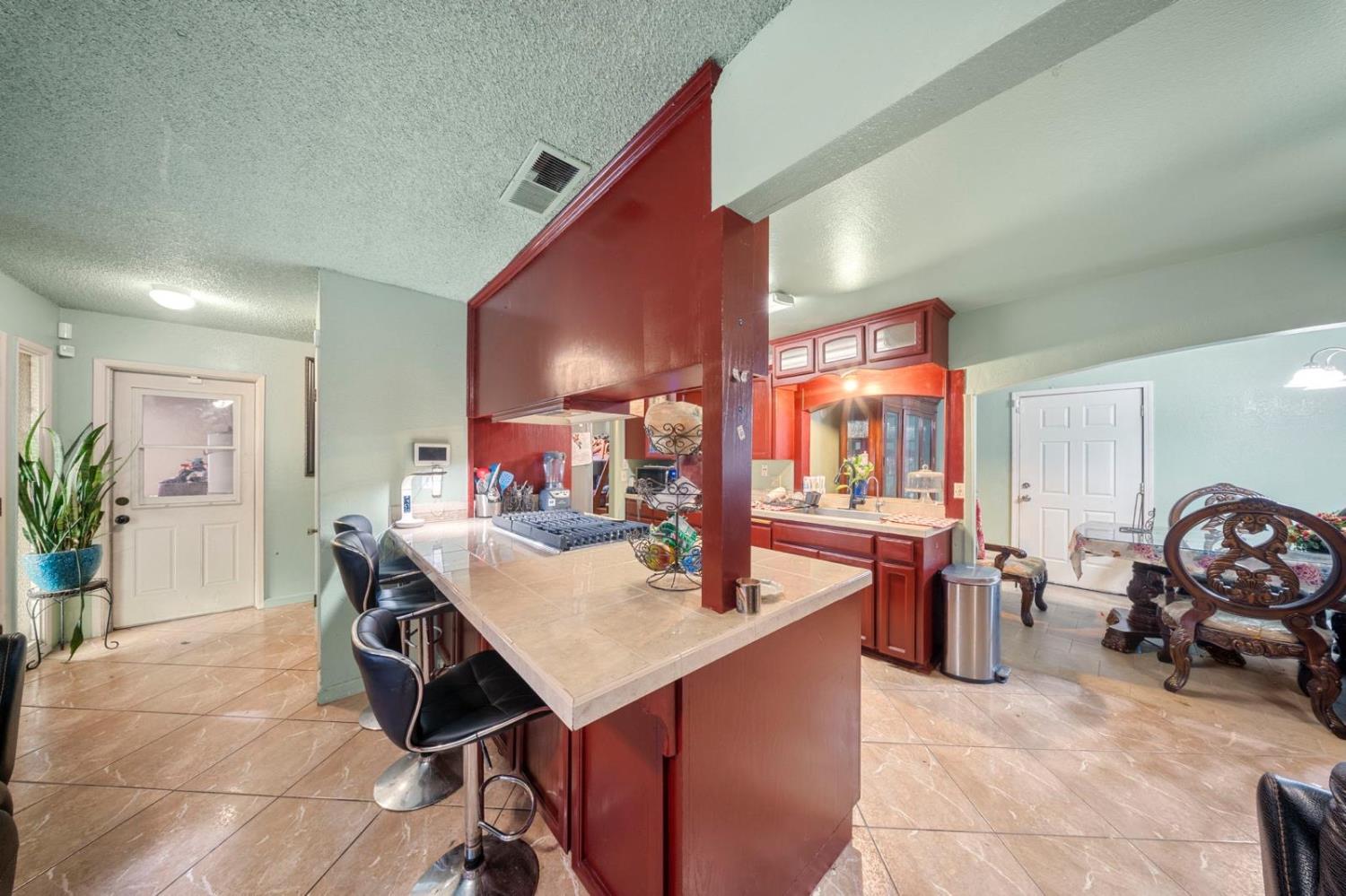 3140 Kellogg Avenue Turlock, CA 95382 - Photo 14 of 22 a view of a dining room with furniture and a potted plant