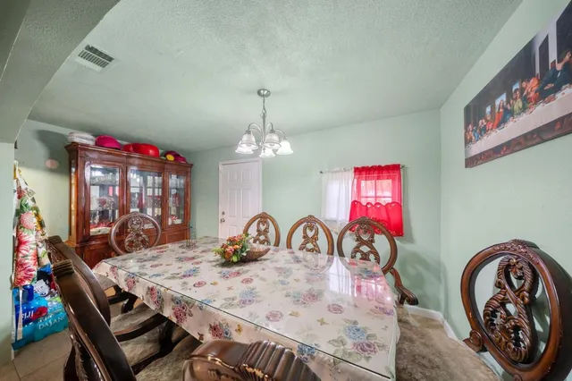 a view of a dining room with furniture and chandelier
