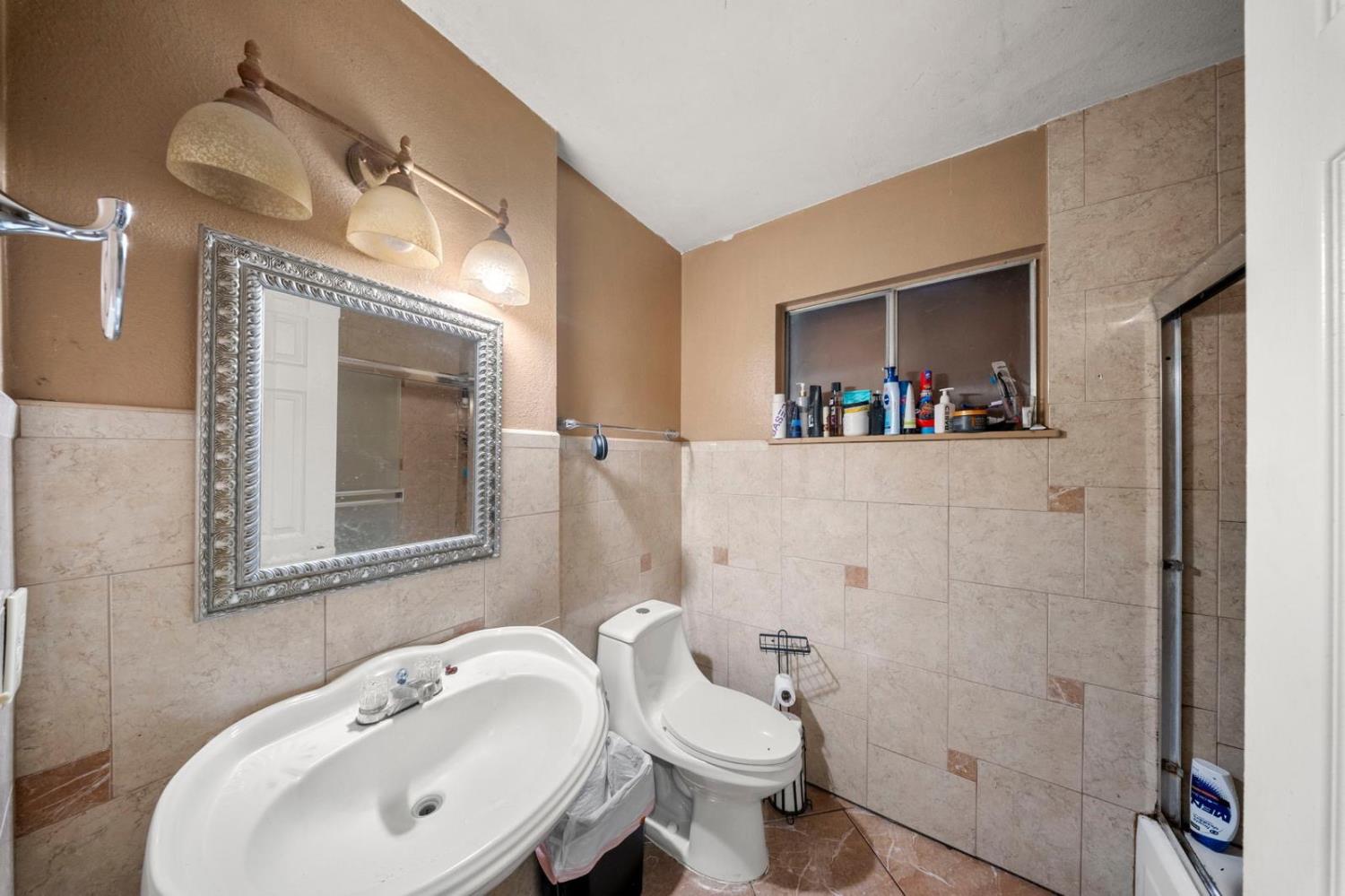 3140 Kellogg Avenue Turlock, CA 95382 - Photo 21 of 22 a bathroom with a sink a toilet and shower