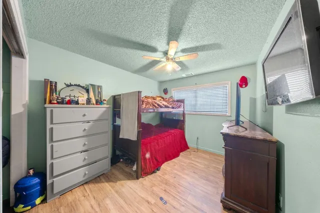 a bedroom with a bed and a chandelier